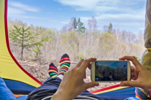 Feet woman relaxing from tent camping outdoor Travel Lifestyle concept nature on background. Summer vacationsFeet woman relaxing from tent camping outdoor Travel Lifestyle concept nature on background. Summer vacations